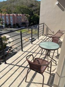 a balcony with a table and chairs and a table at Santa Cruz Condo in Santa Cruz Huatulco