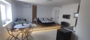 a living room with a table and a couch at Apartmán Domča in Banská Štiavnica