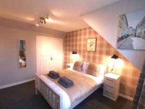 a bedroom with a bed with two pillows on it at Superhost House Brechin sleeps 6, 3 bedrooms in Brechin