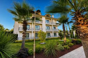 a building with palm trees in front of it at Didi Hotel Sapanca in Sapanca