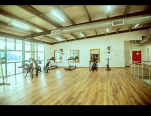 a gym with treadmills and exercise equipment in a room at Eden Heights in Tokuse
