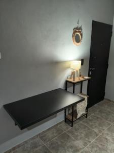 a table in a room with a lamp on a wall at Alojamiento Pasaje Montes in Cruz del Eje +6 photos