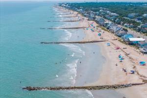 an aerial view of a beach with people on it at The Edistoneyan in Edisto Island