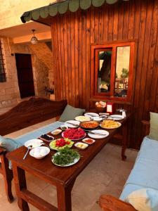 a table with many plates of food on it at Aryan Butik Otel in Mardin
