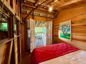 a bedroom with a bed in a log cabin at Les Bananes Vertes Ecolodges in Saint-Claude