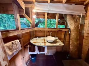 an interior view of a bathroom in a tree house at Les Bananes Vertes Ecolodges in Saint-Claude +195 photos