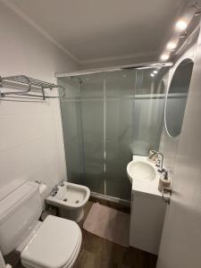 a bathroom with a toilet and a sink and a shower at Torre Alberti Apartments in Mar del Plata