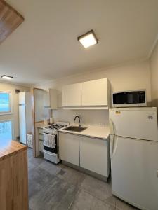 a kitchen with white appliances and a white refrigerator at Torre Alberti Apartments in Mar del Plata