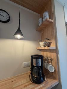a kitchen with a coffee maker and a clock at Torre Alberti Apartments in Mar del Plata