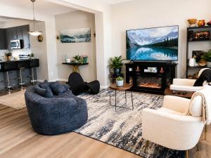 a living room with a couch and a tv at Southside Haven Edmonton in Edmonton