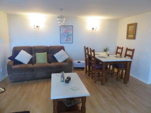 a living room with a couch and a table at The Coach House Self Catering Apartments in Glenariff