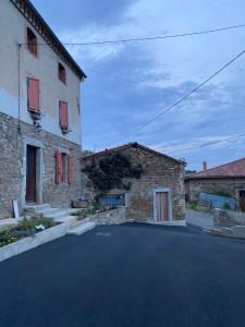 a street in front of a building with red windows at Chez Phil et Marie in Pralong +5 photos