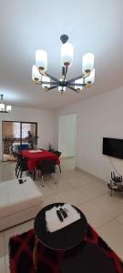a living room with a table and a dining room at Apartamento Condomínio Vila Flor in Viana