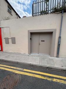a building with a garage door on the side of it at The City Walls Residence in Waterford