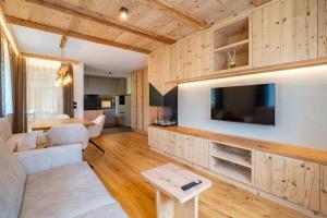 a living room with wooden cabinets and a tv at Lüch dl Chessl - Kesslhof in San Martino in Badia