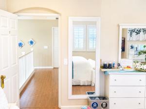 a bedroom with a mirror and a bed at Balloons and Wine in Murrieta +79 photos