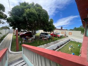 a view from a balcony of a yard with cars parked at Villa Velha Flats in Itamaracá