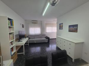 a room with a bed and a desk and a couch at Mirador de Bolnuevo in Bolnuevo