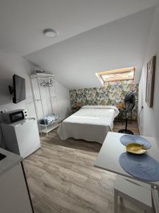 a bedroom with a bed and a tv and a table at Briones al mar in Cambados