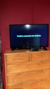 a flat screen tv sitting on top of a dresser at Chez Phil et Marie in Pralong
