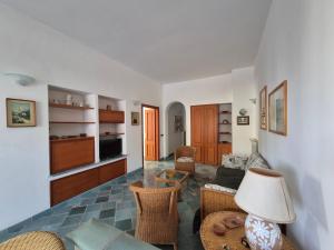 a living room with a couch and a table at Casa Cachepot - Sweet Silvana in Ischia +13 photos