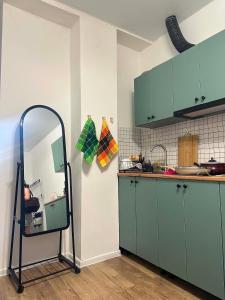 a kitchen with green cabinets and a mirror at Bazaleti Lake Escape in Bazalet'i