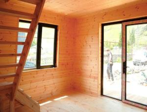 a room in a log cabin with windows at Kazbegi mountain station in Kazbegi