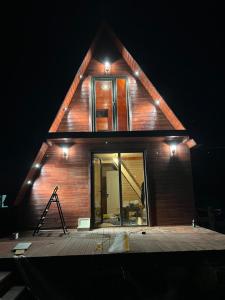 a house under construction at night with lights on it at Kazbegi mountain station in Kazbegi