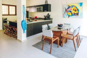 a kitchen and dining room with a table and chairs at Serene Jungle Villa -Steps from the Ocean in Akumal +14 photos