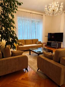 a living room with couches and a tv at Villa Art deco in Dębica