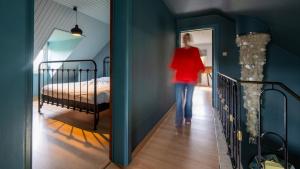 a woman walking down a hallway with a bed at Lumen nr5 in Bois
