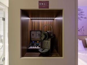 a telephone in a wooden box in a room at Mercure Hotel Berlin City in Berlin +179 photos