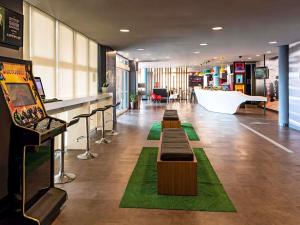 a lobby with tables and a tub in a building at ibis Sao Paulo Interlagos in São Paulo