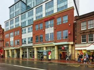 a building on a street with people walking in front of it at ibis Reading Centre in Reading