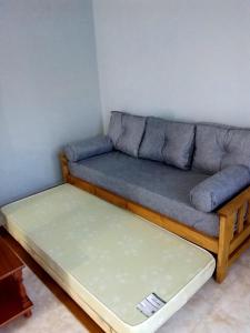 a living room with a couch and a bed at centro 1 in General Roca