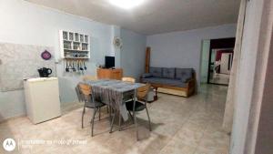a dining room with a table and chairs and a couch at centro 1 in General Roca