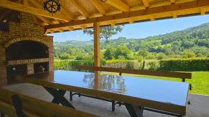 a ping pong table in a patio with a fireplace at Vikendica Sara in Šipovo +57 photos