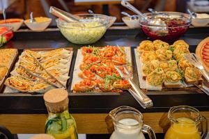 a buffet with many different types of food and drinks at Apartman Tornik Relax&Spa 3 in Zlatibor