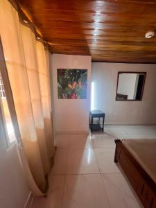 a room with a table and a painting on the wall at Casa solarte in Calobrito