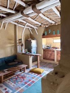 a kitchen with a couch and a table in a room at Hobbit-Hole in Siwa in Siwa +7 photos