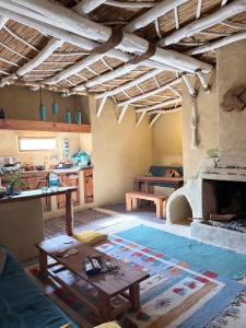 a living room with a table and a fireplace at Hobbit-Hole in Siwa in Siwa