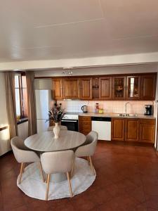 a kitchen with a table and chairs in a kitchen at The Old Bakery in Grimstad