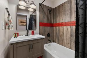a bathroom with a sink and a mirror and a tub at Boerne Birdie Ranch in Boerne +20 photos