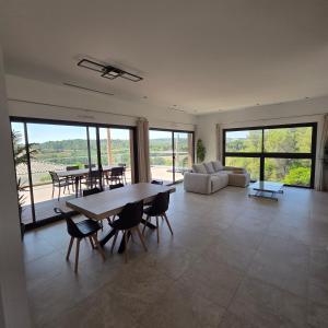 a large living room with a table and chairs at Villa View in Combaillaux