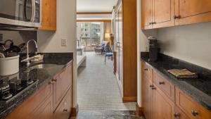 a kitchen with a sink and a counter top at 347 Lodge At Spruce Peak Ski In Ski In Ski Out King Studio By Stowe Mountain Rentals in Stowe