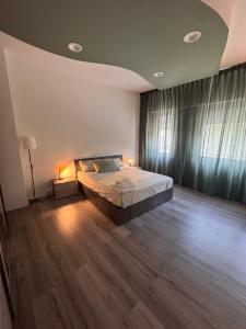 a bedroom with a large bed and a wooden floor at Le due dimore del Baluardo in Novara