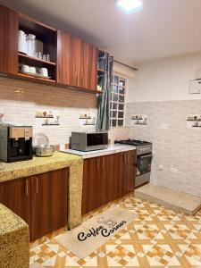 a kitchen with wooden cabinets and a counter top at 2020 suites utawala in Nairobi