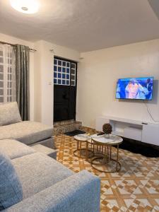 a living room with a couch and a table at 2020 suites utawala in Nairobi