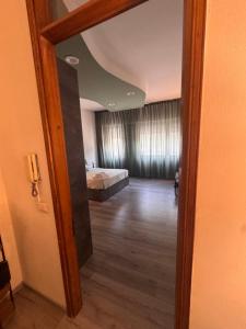 a room with a bedroom with a bed and a mirror at Le due dimore del Baluardo in Novara +1 photo