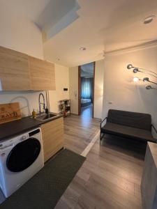 a kitchen with a sink and a stove top oven at Le due dimore del Baluardo in Novara